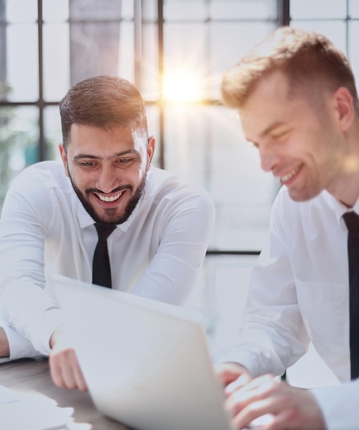 Two happy men working together on a new business project