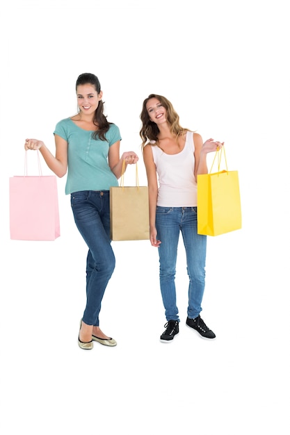 Two happy young female friends with shopping bags