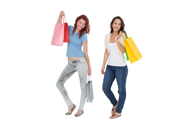 Two happy young female friends with shopping bags