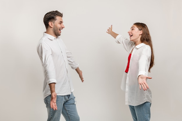 Two happy young people friends couple hug and smile after a long time apart face to face