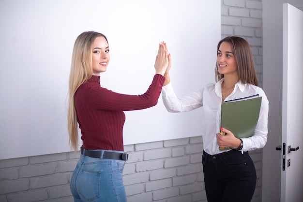 Two hardworking young female entrepreneurs working together