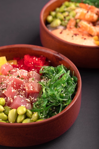 Two hawaiian poke bowls with tuna fish and shrimp