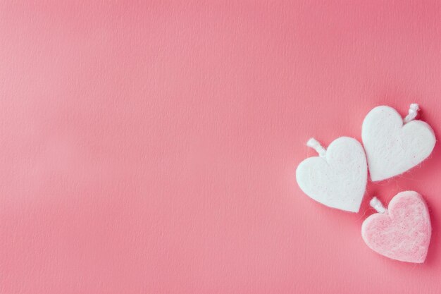 Two Heart Shaped Marshmallows on Pink Background