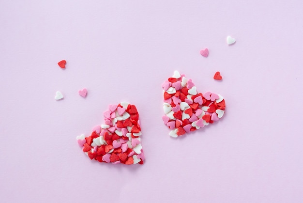 Two hearts made from little red, white and pink sugar hearts