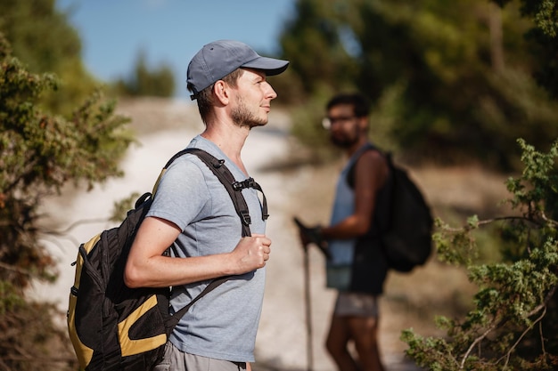 Two hikers men walk on trek in mountain Trekking in mountains Hills and mounts in sport tourism