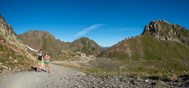 Two hikers women on the path in the french Pyreneees mountains