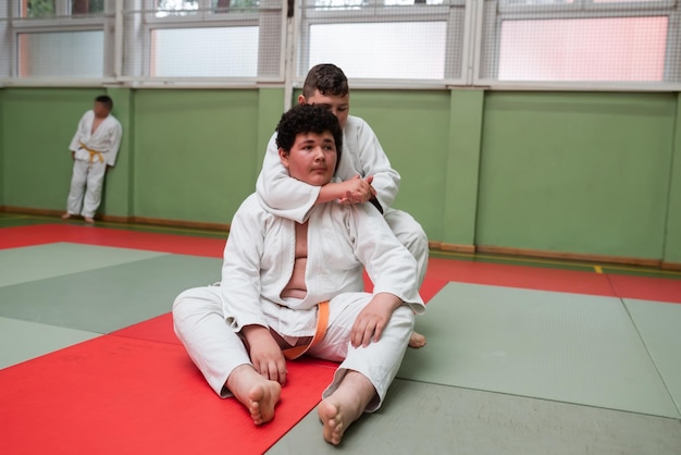 Two judo fighters showing technical skill while practicing martial arts in a fight club The two fit men in uniform fight karate training arts athlete competition conceptSelective Focus