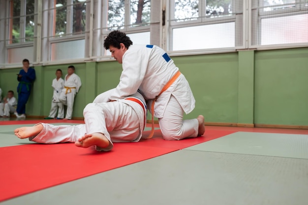 Two judo fighters showing technical skill while practicing martial arts in a fight club The two fit men in uniform fight karate training arts athlete competition conceptSelective Focus