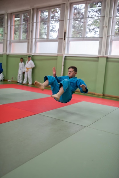 Two judo fighters showing technical skill while practicing martial arts in a fight club The two fit men in uniform fight karate training arts athlete competition conceptSelective Focus