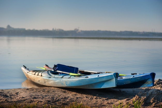 Two kayaks on the shore of the lake active recreation at the weekend on the water