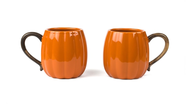 Two large pumpkin-shaped mugs isolated on a white background.