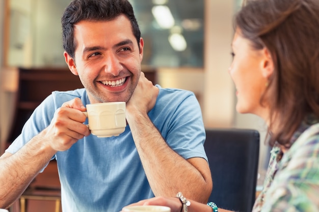 Two laughing students having a cup of coffee