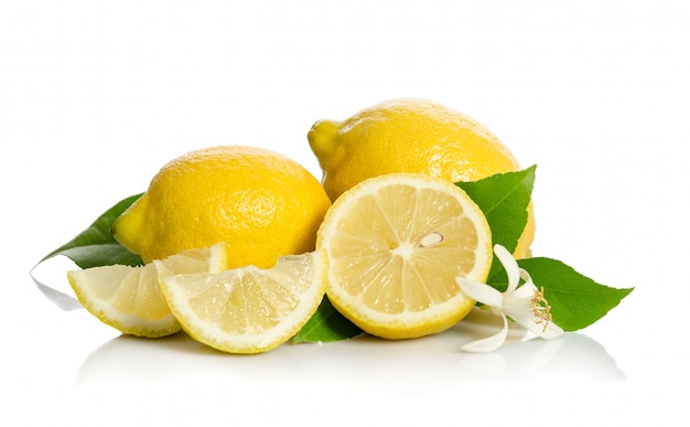 Two lemons and a half with leaves on a bright background