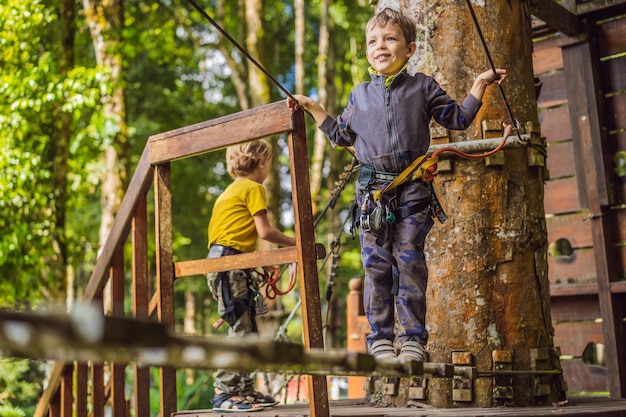 Two little boys in a rope park Active physical recreation of the child in the fresh air in the park Training for children