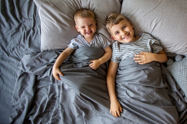 Two little brothers lying in bed