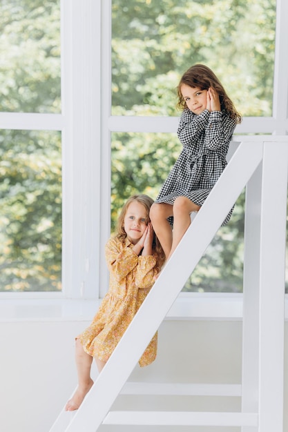 Two little sisters in studio