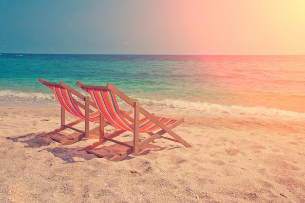 Two lounge chairs on the beach