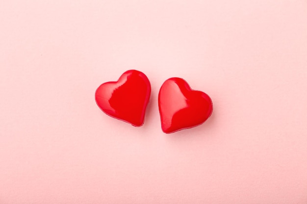 Two love hearts on pink background