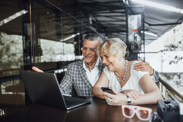 Two lovely seniors parents chating with their children in laptop