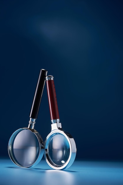 Two magnifying glass against blue background