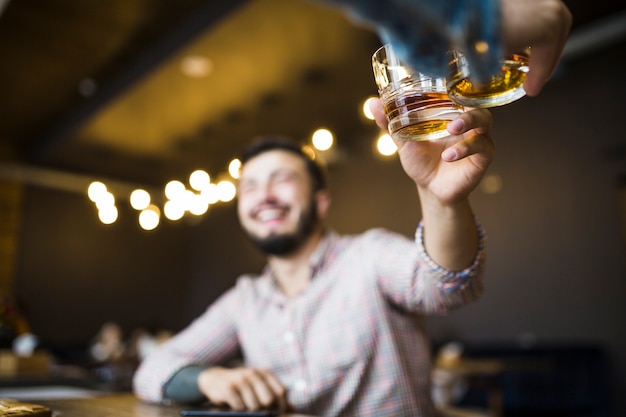 Two male friends raising toast