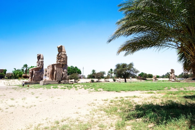 Two massive stone statues of Pharaoh Amenhotep III