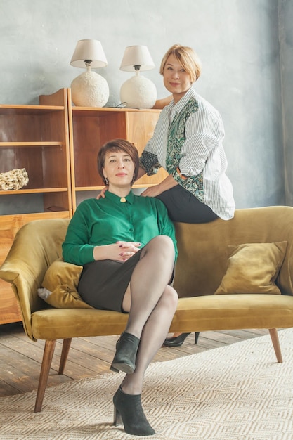 Two mature women with short hair at home