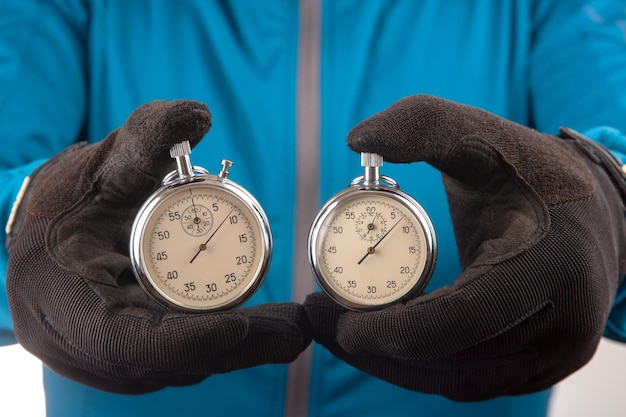 Two mechanical stopwatches in a male hand Time part precision Measurement of the speed interval