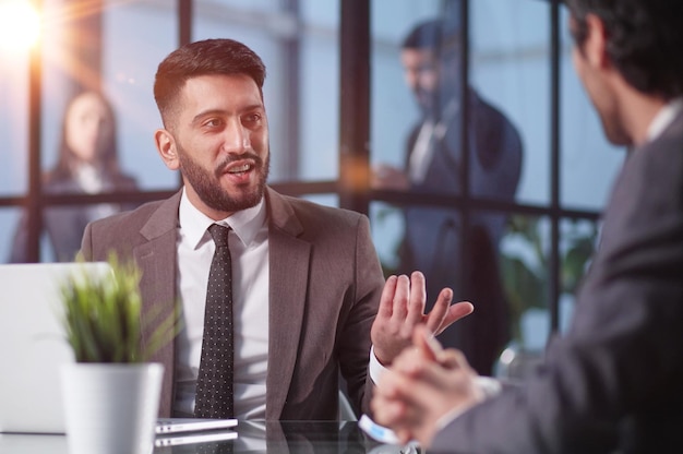 Two medium focused business workers communicate in the office