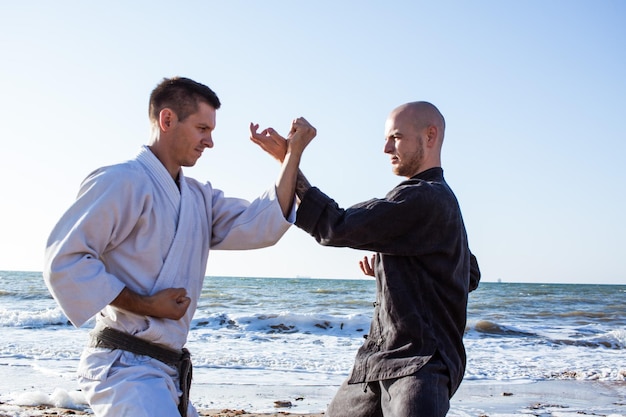 two men are wearing black shirts and one has a blue bracelet on his wrist