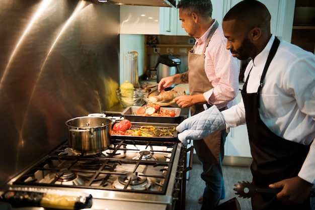 Two men cooking in a kitchen