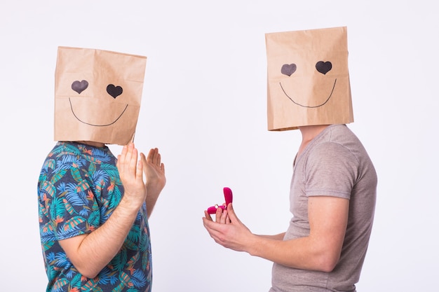 Two men get engaged gay engagement on white background