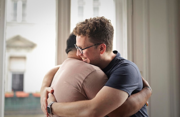 two men hug each other in the house