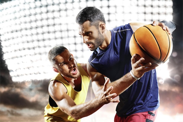 Two men playing basketball on a court