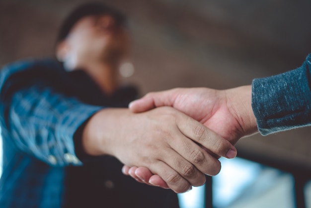 Two men shaking hands after meeting and exchanging ideas and finding mutual agreement . 