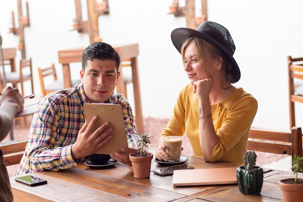 Two mid age people ordering in a restaurant