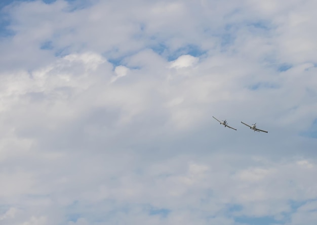 Two military aircrafts flying in the cloudy sky