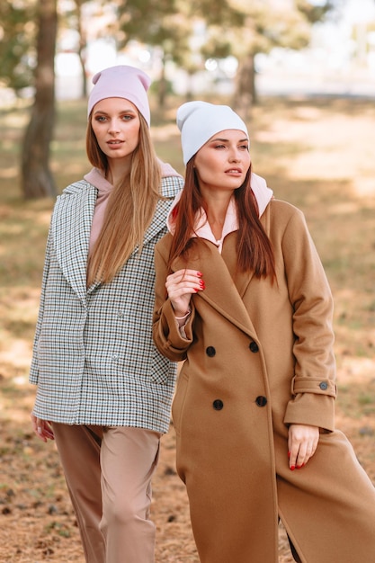 Two model girls showing fashionable outdoor sportswear on the street Clothes from the showroom