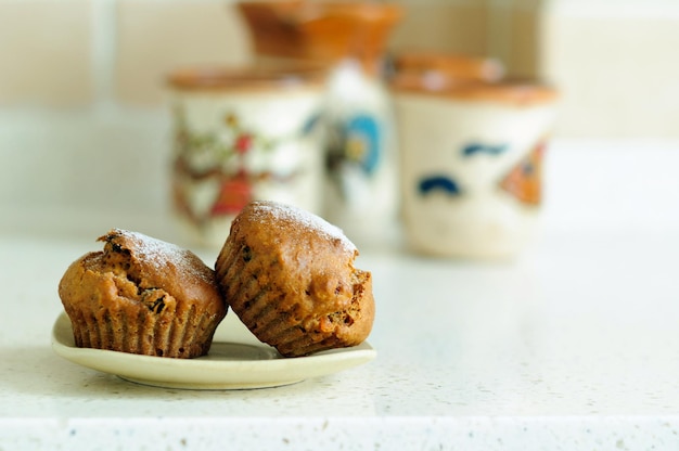 Two muffins with dried fruits and powdered sugar selective focus