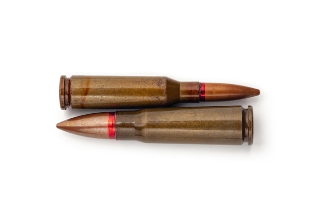 Two old bullets for automatic rifles of 545 and 762 caliber on a white background