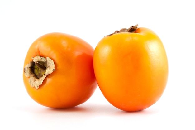 Two orange fresh organic persimmon on white background