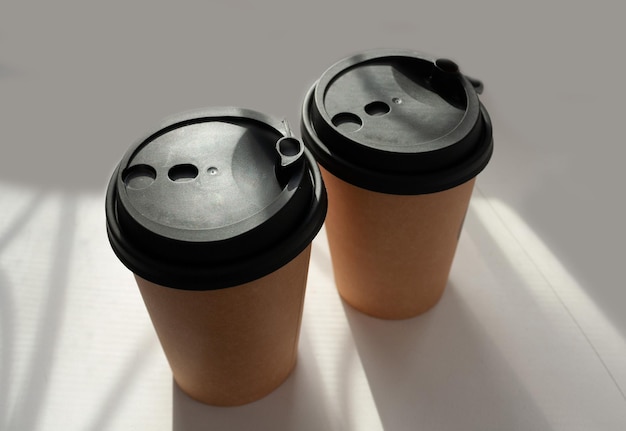 Two paper cups with coffee on the window food delivery