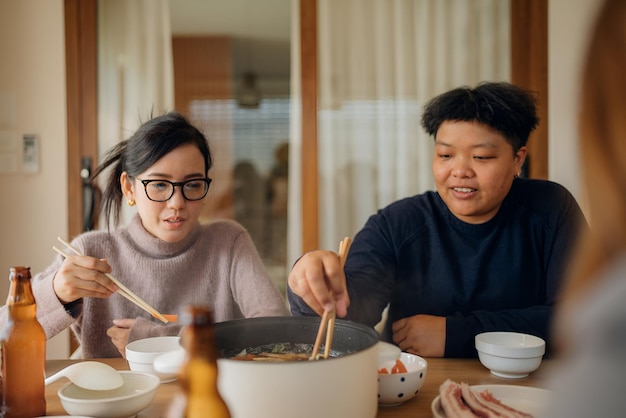 two people are eating a meal with chopsticks