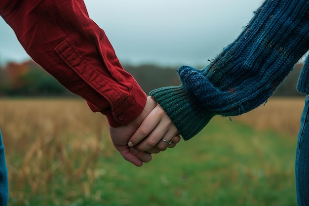 Photo two people holding hands one of which has the word quot on it