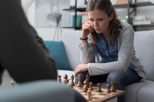 Two people playing chess at home