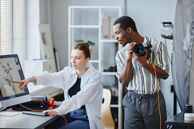 Two Photographers Working In Studio