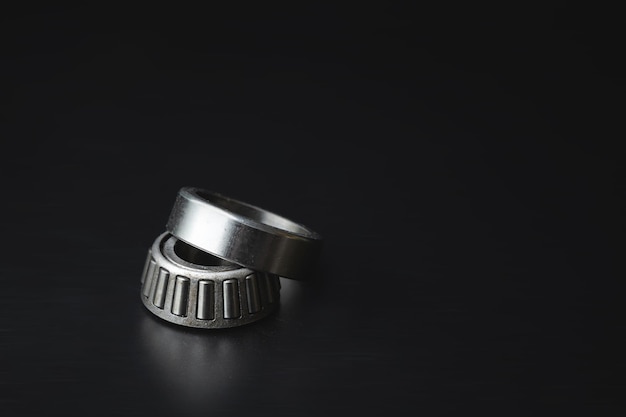 Photo two-piece tapered bearing new spare part on a black background