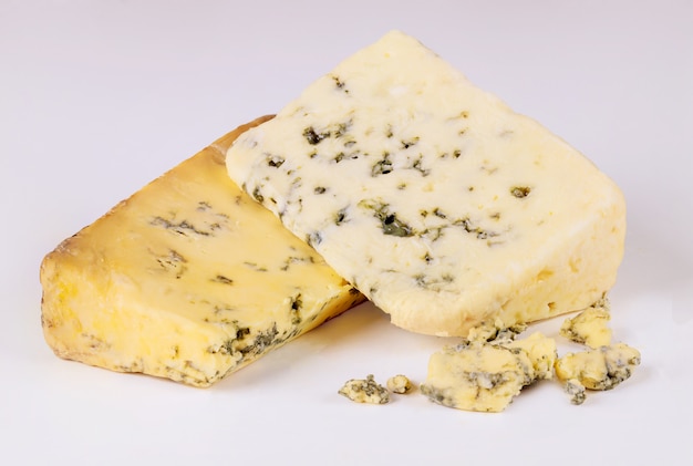 Two pieces of blue cheese with mold