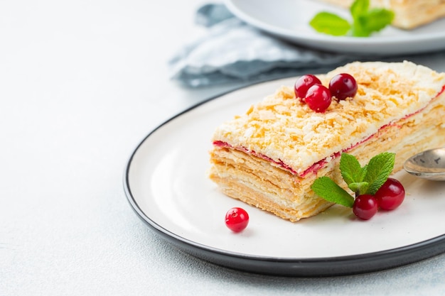 Two pieces of cake Napoleon on white plate Russian cuisine multi layered cake with pastry cream close up view With copy space