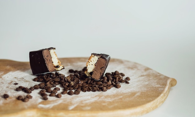 Two pieces of cottage cheese dessert on a wooden background with coffee beans